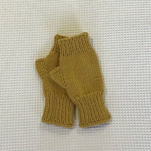 Women’s fingerless mittens, hand-knitted using fine merino yarn, available in a variety of colours.