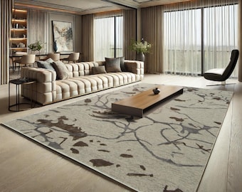 May include: A contemporary living room with a large beige sofa, a wooden coffee table, and a patterned rug. The room features large windows with sheer curtains, a black chair, and a neutral colour palette. A painting hangs on the wall.