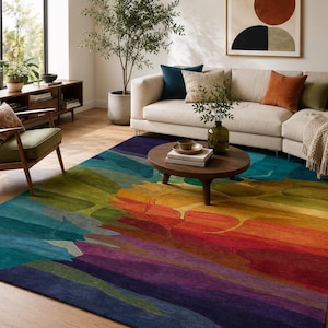 May include: A multi-coloured area rug with an abstract design. The rug displays a spectrum of colours, including blues, greens, yellows, oranges, and purples, creating a visually striking and artistic statement. The rug is placed in a living room setting.