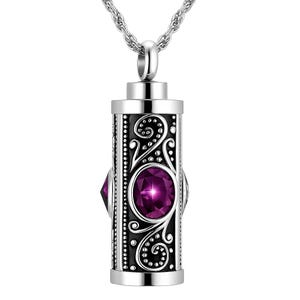 May include: A silver-toned pendant necklace with a rectangular, ornate locket. The locket features a large, oval, purple gemstone and smaller purple gems. The design includes scrollwork and a beaded border. The chain is a twisted rope style.