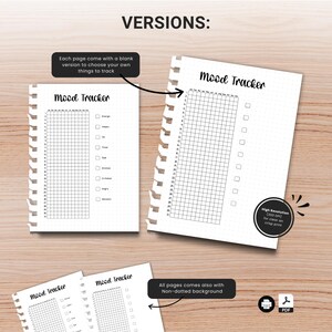 May include: Several white spiral-bound "Mood Tracker" pages with grid layouts and checkboxes are displayed. The text "VERSIONS:" and other descriptive text are also visible. The pages are on a light brown wooden surface.