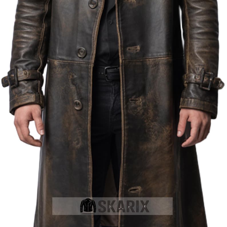 May include: A distressed brown leather trench coat with a button-up front and buckle details on the sleeves. The coat has a vintage, worn appearance. The Skarix logo is visible at the bottom.