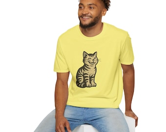 May include: A pale yellow t-shirt with a smiling cat design in black and beige. The cat is depicted sitting up. The t-shirt is made of a soft material and has short sleeves.