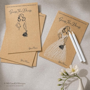 May include: Kraft paper "Guess The Dress" game cards with a bride illustration and text. The cards feature a sketch of a bride in a wedding dress, with space for a name. Two white pencils and flowers are also present.