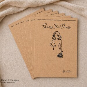May include: A pile of tan kraft paper cards, each with the text "Guess The Dress" and a drawing of a woman. The cards have the text "Can You Guess What Kind of Dress the Bride Will Wear on Her Big Day?" printed on them.