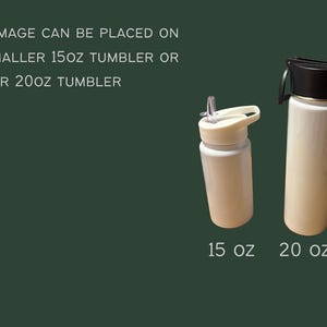 May include: Two white tumblers with black and white lids are displayed against a dark green background. The smaller tumbler is 15 oz, and the larger one is 20 oz. Text on the image reads: "ANY CUSTOM IMAGE CAN BE PLACED ON EITHER THE SMALLER 15oz TUMBLER OR LARGER 20oz TUMBLER."
