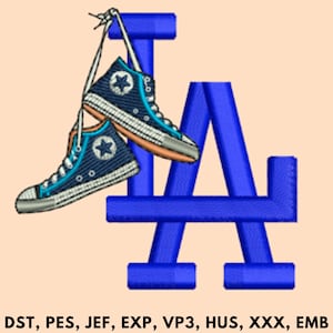 May include: Embroidered design featuring a pair of navy blue high-top sneakers with a white star and accents, hanging in front of a blue "LA" logo. The sneakers have white laces and a light orange trim. The design is on a light peach background.