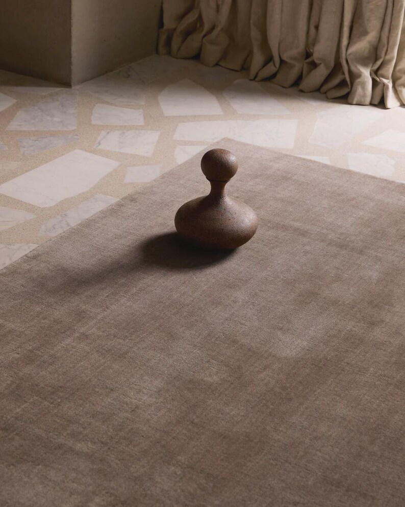 Hand tufted solid brown wool rug in modern living room, minimalist neutral carpet with soft texture and luxury finish for home decor