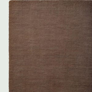 Hand tufted solid brown wool rug in modern living room, minimalist neutral carpet with soft texture and luxury finish for home decor