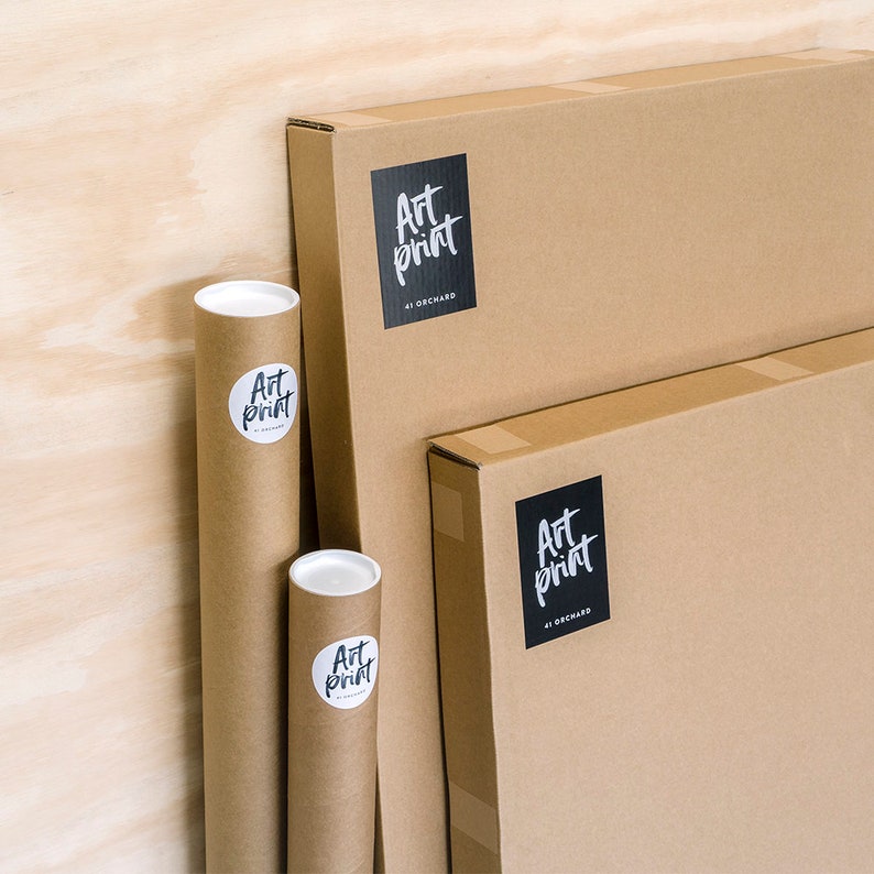 May include: Three brown cardboard boxes with black labels that say "Art Print 41 Orchard" on them. Two of the boxes are rectangular and one is a round tube.