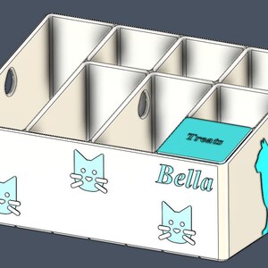 May include: A white rectangular storage organizer with six compartments of varying heights. The front and side feature light blue cat silhouettes and the name Bella. One compartment has a light blue lid with the word Treats printed on it.