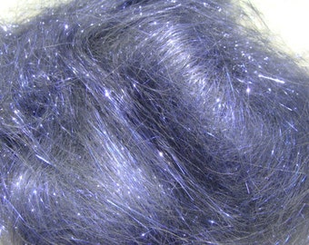 May include: Close-up of a bundle of blue-gray craft material with a shimmering, glittery effect. The fibers are long and flowing, creating a textured appearance. The material reflects light, adding a sparkling quality to the overall look.