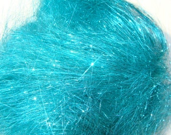 May include: A close-up of teal blue iridescent fiberfill. The fiberfill is made of thin, shiny strands that are tightly packed together.