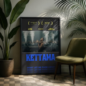 May include: A framed poster featuring the name "KETTAMA" in blue block letters. The poster includes text that reads "IT GETS BETTER", "YOSEMITE", and "PRETTY GREEN EYES". The image shows a person on stage with a crowd in the background.