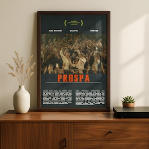 May include: A framed vertical poster featuring a dark background with a central photograph of a crowd at a concert. The text includes "DJ MAG BEST PRODUCER NOMINEE," "THIS RHYTHM," "DREAMS," "PRAYER," "PROSPA," and two paragraphs of descriptive text.