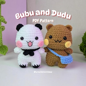 May include: Two crocheted amigurumi figures: a panda and a bear. The panda is white with black ears and a black bow tie. The bear is brown with a blue bag. The text "Bubu and Dudu PDF Pattern" is at the top.