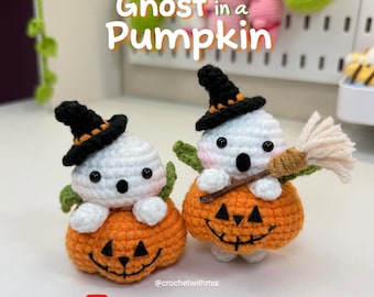 May include: Two crocheted Halloween ghost figures, each perched in an orange pumpkin. The ghosts wear black witch hats with orange trim and have black button eyes. One ghost holds a small broom. The text "Ghost in a Pumpkin" is at the top.