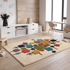 May include: A rectangular area rug with a cream-colored base featuring a geometric pattern of multi-colored squares and rectangles in shades of green, blue, orange, brown, and yellow, accented by thin black lines and starburst shapes.