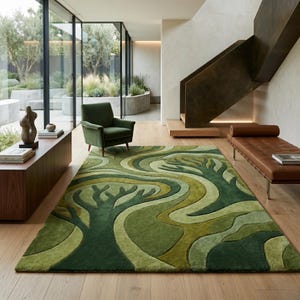 May include: A green area rug with a tree design in varying shades of green. The rug is placed on a wooden floor in a modern living room setting. A green armchair and a brown leather bench are also visible.