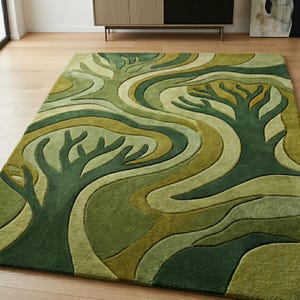 May include: A rectangular area rug with a nature-inspired design. The rug features a pattern of stylized trees and flowing lines in shades of green and olive. The rug is placed on a wooden floor.