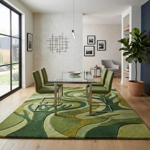 May include: A modern dining room featuring a glass-top table with silver legs and four green upholstered chairs. A large green rug with a flowing, organic pattern covers the floor. A large potted plant and framed artwork complete the space.
