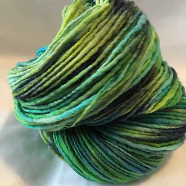 Hand spun hand painted Aran weight Merino wool yarn.  Shades of blue and green and chartreuse.  100 g./3.5 oz.  220yds. Two skeins available