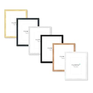 May include: A selection of rectangular picture frames in gold, black, white, and natural wood. Each frame has a white mount and the word "YUM" printed on it. The frames are arranged diagonally against a white background.