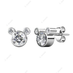 May include: A pair of silver-toned stud earrings. Each earring features a large, round, clear gemstone at the center, with two smaller gemstones above, forming a Mickey Mouse head shape. The gemstones sparkle brightly.