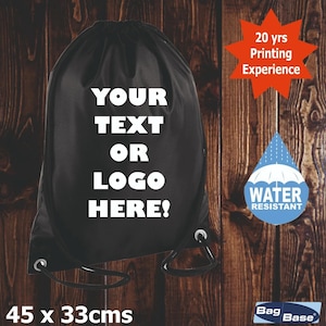 May include: A black drawstring backpack featuring the white text YOUR TEXT OR LOGO HERE! on the front. The bag measures 45 x 33 cm. An orange starburst graphic states 20 yrs Printing Experience, and a blue water drop icon says WATER RESISTANT.