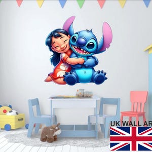 May include: A vibrant wall sticker depicting Lilo and Stitch embracing. Lilo is in a red dress, and Stitch is blue with large ears. The sticker is on a white wall, with a small table and chairs in the foreground.
