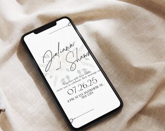 May include: A smartphone screen shows a wedding invitation with the names "Juliana and Shawn" in cursive. The invitation includes the date 07.26.25 and the time and location. The phone is on a beige fabric.