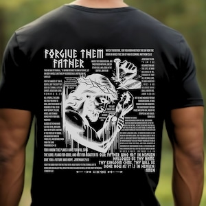 May include: Black t-shirt with a white graphic of Jesus Christ on the cross. The graphic includes the text "Forgive Them Father" and several Bible verses.
