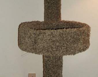 May include: A brown cat tree with a platform and a base. The cat tree is covered in brown carpet.