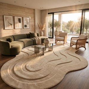 May include: A large, beige area rug with a textured, wavy, layered design that creates a topographical effect. The rug features concentric, raised, curved lines that follow an irregular, organic shape, covering a significant portion of the floor.