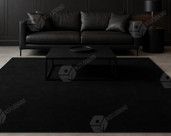 May include: A large, solid black rectangular area rug centered on a light-colored tiled floor. The rug features a uniform, deep black color and a smooth, low-pile texture, providing a stark contrast to the surrounding neutral-toned floor tiles.