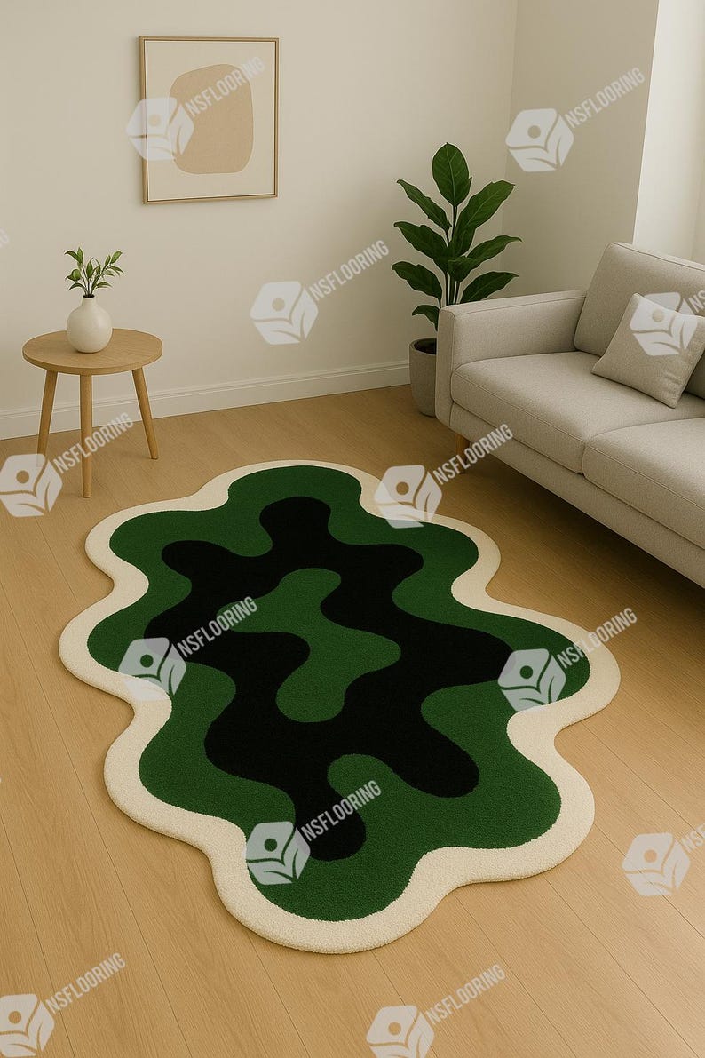 May include: A modern area rug with an abstract design. The rug features a wavy pattern in shades of green and black, outlined with a cream-colored border. It is placed on a light-colored wooden floor, complementing the neutral tones of the room.