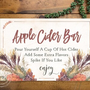 May include: A sign for an apple cider bar with fall-themed watercolor illustrations. The sign reads "Apple Cider Bar" and includes instructions to "Pour yourself a cup of hot cider, add some extra flavors, spike if you like, enjoy".
