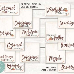 May include: A set of printable labels for a fall-themed party. The labels are designed to be used as tent cards for a variety of drinks and flavor add-ins. The labels feature a rustic, autumnal design with brown and red accents. The labels include text such as "Caramel Sauce", "Cinnamon Sticks", "Red Hots", "Fresh Apple Slices", "Fireball Whiskey", "Spiced Rum", "Caramel Vodka", "Bourbon", "Tequila", "Brandy", "Dried Orange Slices", "Cinnamon Powder", and "Rosemary Sprigs".