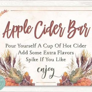 May include: A sign with a fall-themed design reads "Apple Cider Bar". It instructs guests to pour themselves a cup of hot cider, add some extra flavors, and spike if they like. The sign also says "enjoy" in a decorative font.