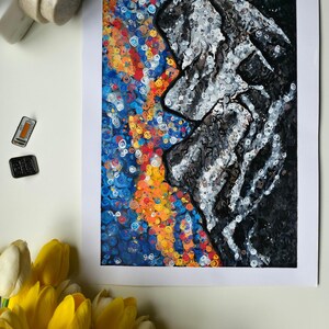 May include: Abstract art print featuring a profile in black and white against a vibrant background of blue, orange, and yellow swirls. The artwork is framed in white and is displayed with yellow tulips and decorative objects.