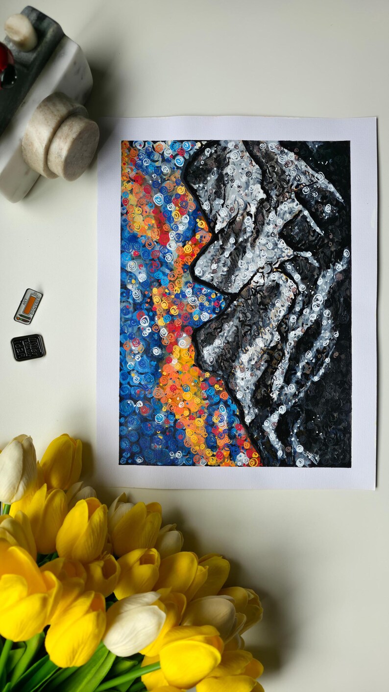 May include: Abstract art print featuring a profile in black and white against a vibrant background of blue, orange, and yellow swirls. The artwork is framed in white and is displayed with yellow tulips and decorative objects.