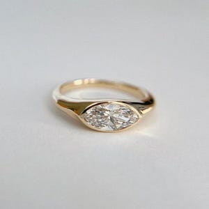 14K Gold Marquise Moissanite Engagement Ring: East-West Bezel Solitaire