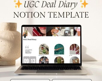 May include: A laptop displays a Notion template titled "UGC Deal Diary." The screen shows a grid of images and text, with the words "500+ Brand Emails!" and "UGC Pitch Tracker" below. The laptop is open on a white surface.