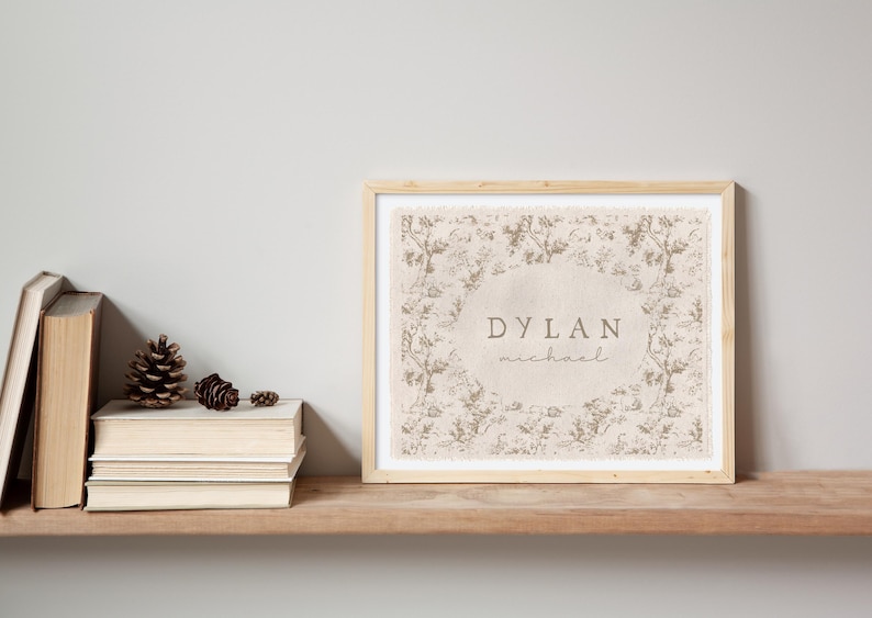 May include: A framed print with a floral design and the name "DYLAN michael" in a beige color.