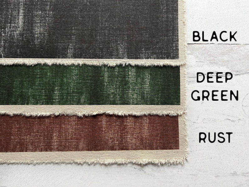 May include: Three fabric swatches in black, deep green, and rust. Each swatch has a distressed, textured appearance and a frayed edge. The words "BLACK", "DEEP GREEN", and "RUST" are printed in black.
