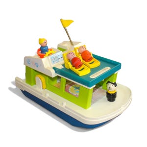 May include: A vintage Fisher-Price toy boat in white, blue, and green. The toy boat features a yellow flag, two figures in yellow lounge chairs, a captain at the helm, and a dog figurine. The boat has the words "Fisher-Price" printed on the side.