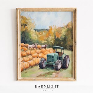 May include: A framed oil painting print featuring a green tractor parked in a field of orange pumpkins with three sheep standing nearby. The background shows a landscape with yellow and green trees under a light blue sky. The text BARNLIGHT PRINTS appears below.