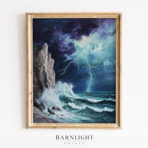 May include: A framed print of a seascape depicting a stormy ocean scene. The artwork features a dramatic sky with dark clouds and a lightning strike over the turbulent sea. The print is framed in a gold-colored wooden frame. The text "BARNLIGHT PRINTS" is at the bottom.