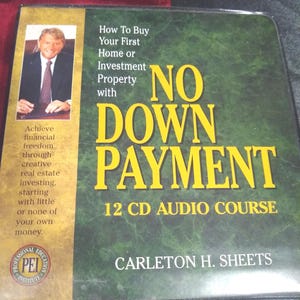 May include: A green and black CD case with the title "NO DOWN PAYMENT" in large yellow letters. The case also features text that reads "How To Buy Your First Home or Investment Property" and "12 CD AUDIO COURSE". A photo of a man in a suit is on the left.