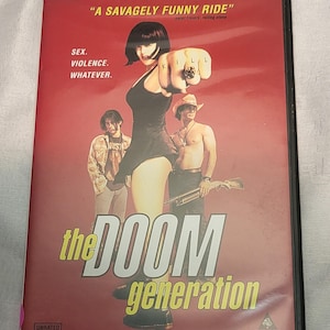 May include: DVD case for "The Doom Generation" with a red background. The cover features a woman pointing a fist with the word "KILL" on her knuckles, and the text "SEX. VIOLENCE. WHATEVER."